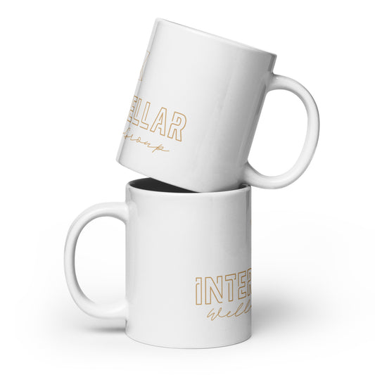 Two white mugs with gold text on a white background